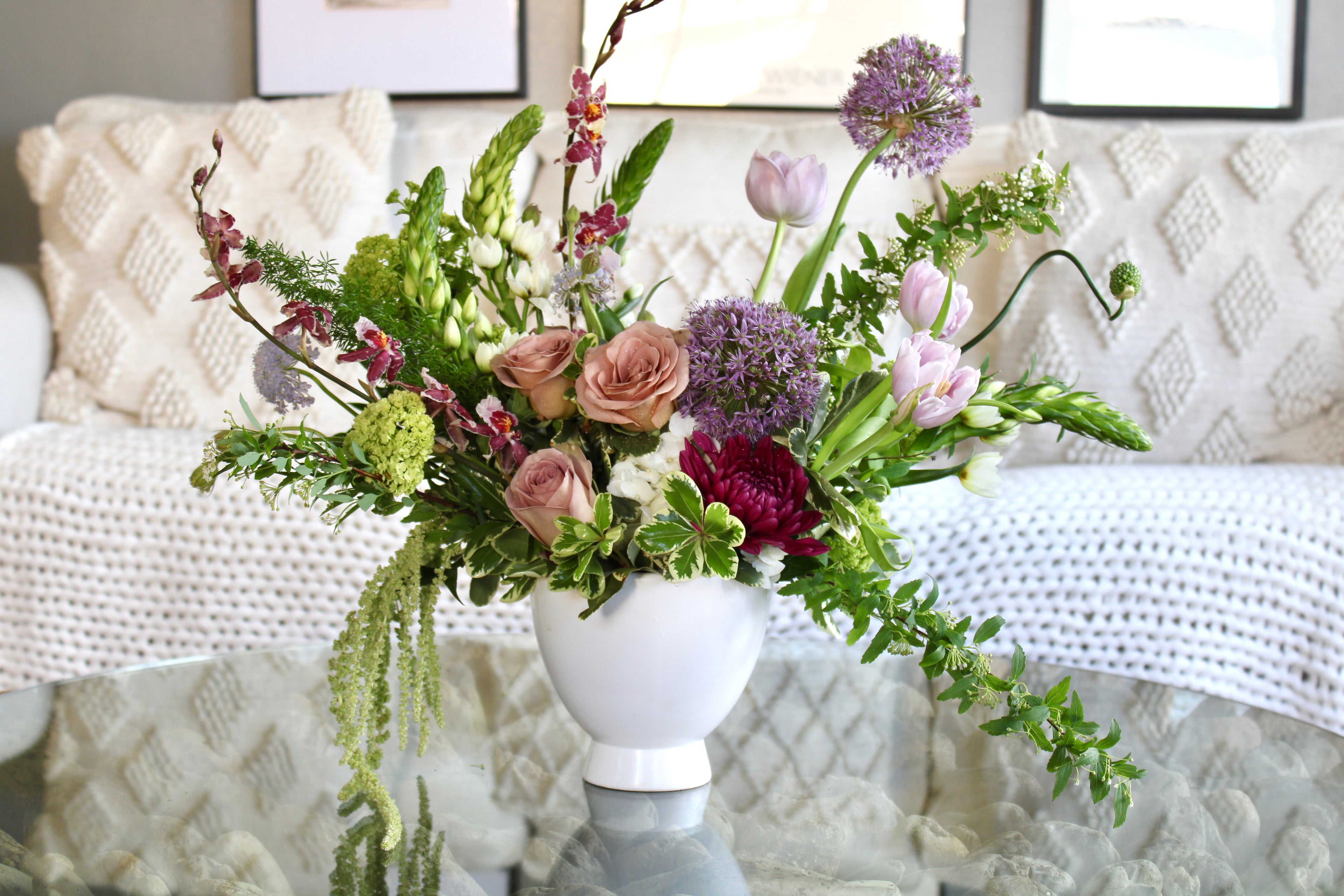 Soft blush floral arrangement with mauve, blush, and lavender blooms in a ceramic vase.