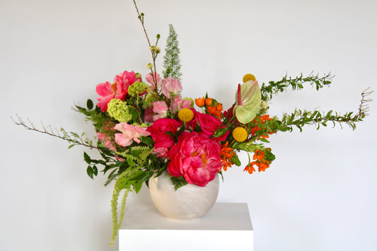 Soft blush floral arrangement with suave, blush, and lavender blooms in a ceramic vase